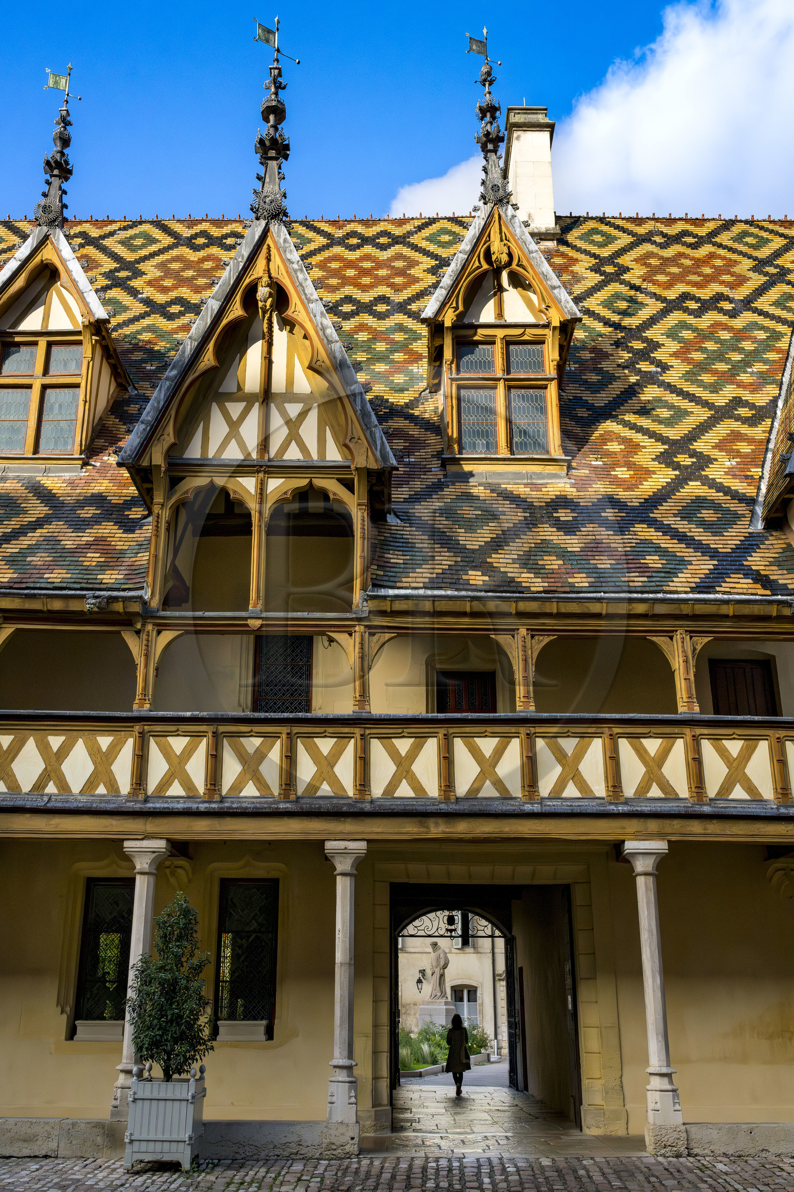 France, Cote d'Or, Beaune, area listed as World Heritage by UNESCO, Hospices de Beaune, Hotel Dieu courtyard of honor, statue of Nicolas Rolin who created the hospices with his wife Guigone de Salins