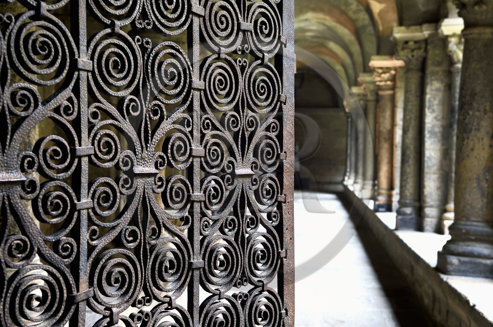 France, Haute Loire, Le Puy en Velay, Routes of Santiago de Compostela, the 12th century Our Lady (Notre-Dame-de-l'Annunciation) cathedral listed as World heritage by UNESCO, the cloister, Romanesque wrought iron gate made at the beginning of the 12th century which closes the passage leading to the cathedral