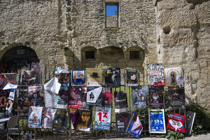 France, Vaucluse, Avignon, Rue de la Peyrolerie in the old town with posters announcing the festival shows