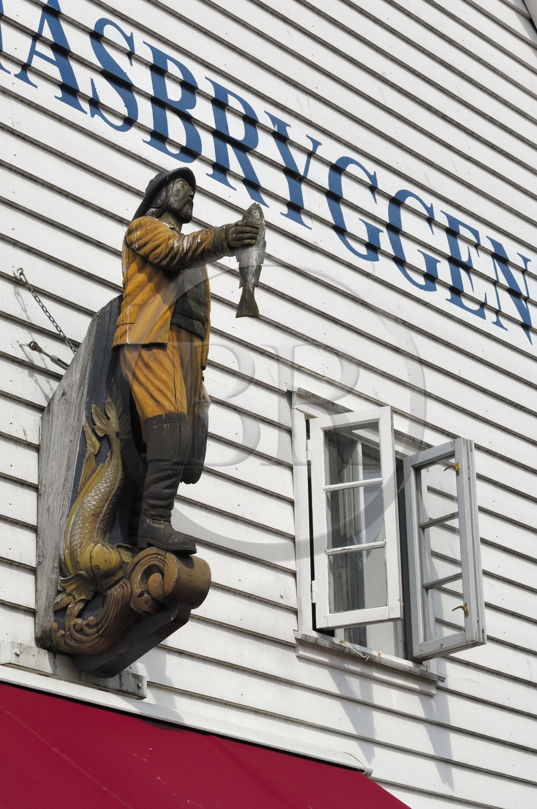 Norway, Hordaland, Bergen, fisherman statue on a wooden house facade
