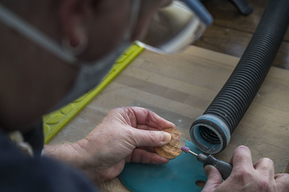 France, Côtes-d'Armor, Tréguier, one of the Le Poupon sisters who are artisans of Art nacrier, works the mother-of-pearl of abalone shell in the Ys Paris creation workshop