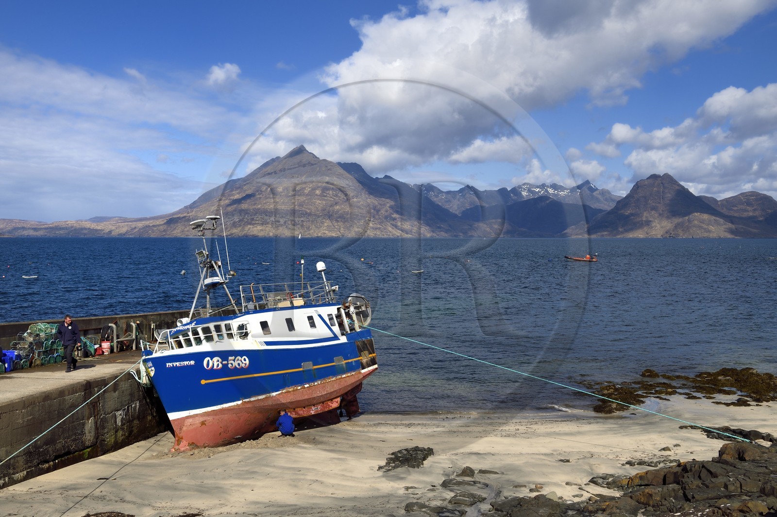 United Kingdom, Scotland, Highlands, Hebrides, Isle of Skye, fishing boat in the small port of the Elgol village on the shores of Loch Scavaig towards the end of the Strathaird peninsula and the Black Cuillin Mountains in the background