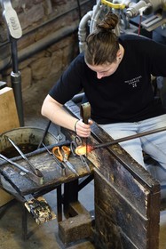 France, Moselle, Meisenthal, Centre international d'Art verrier (CIAV) (international glass centre), the blowing workshop, crafting a Christmas ball, the prompter regulates the mass at home plate while performing a continuous rotation of his cane and preparation of the parison before passing to the mold