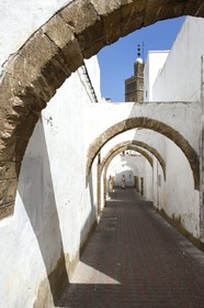 Morocco, Casablanca, Habous district built between 1917 and 1955 by architects Auguste Cadet and Edmond Brion, street with arcades and Moulay Youssef Mosque in the background
