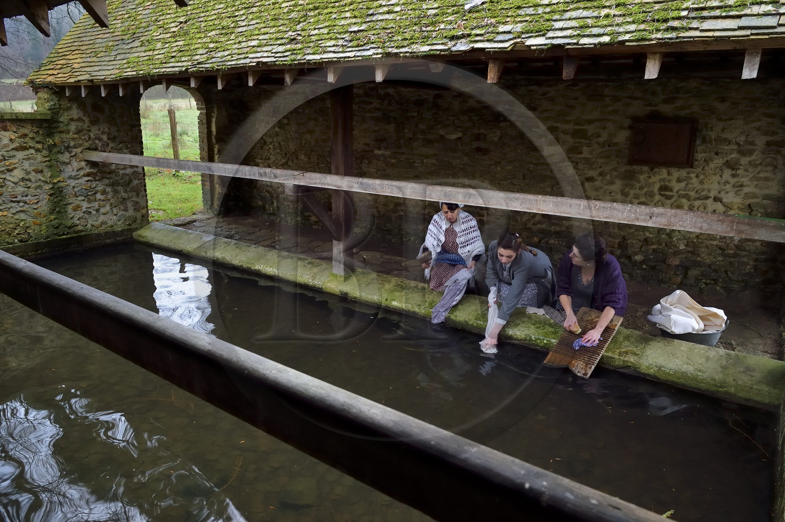France, Eure (27), lavoir de Sainte-Colombe-prés-Vernon, Allied Reconstitution Group (association de reconstitution historique de la 2éme Guerre Mondiale US et Maquis), les reconstitueurs montrant trois femmes lavant de linge au lavoir dans les années 1940