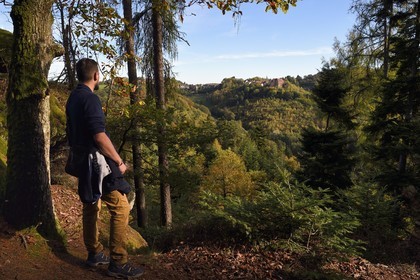 France, Bas-Rhin, Parc regional des Vosges du nord (Northern Vosges Regional Natural Park), La Petite Pierre, hiker at the Rocher Blanc (White Rock) which allows to enjoy a beautiful view of the old town and the Chateau