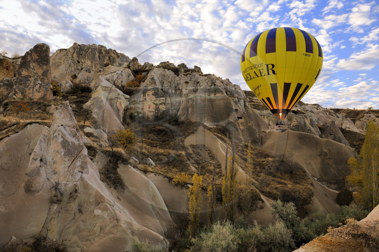 Turkey, Central Anatolia, Nevsehir Province, Cappadocia listed as World Heritage by UNESCO, hot air baloon flying over Balkan Valley in Ortahisar (aerial view)