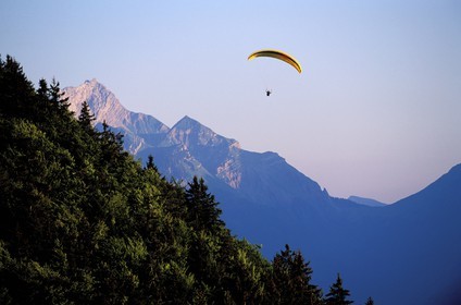 France, Haute Savoie, paraglider at Forclaz pass over Annecy lake