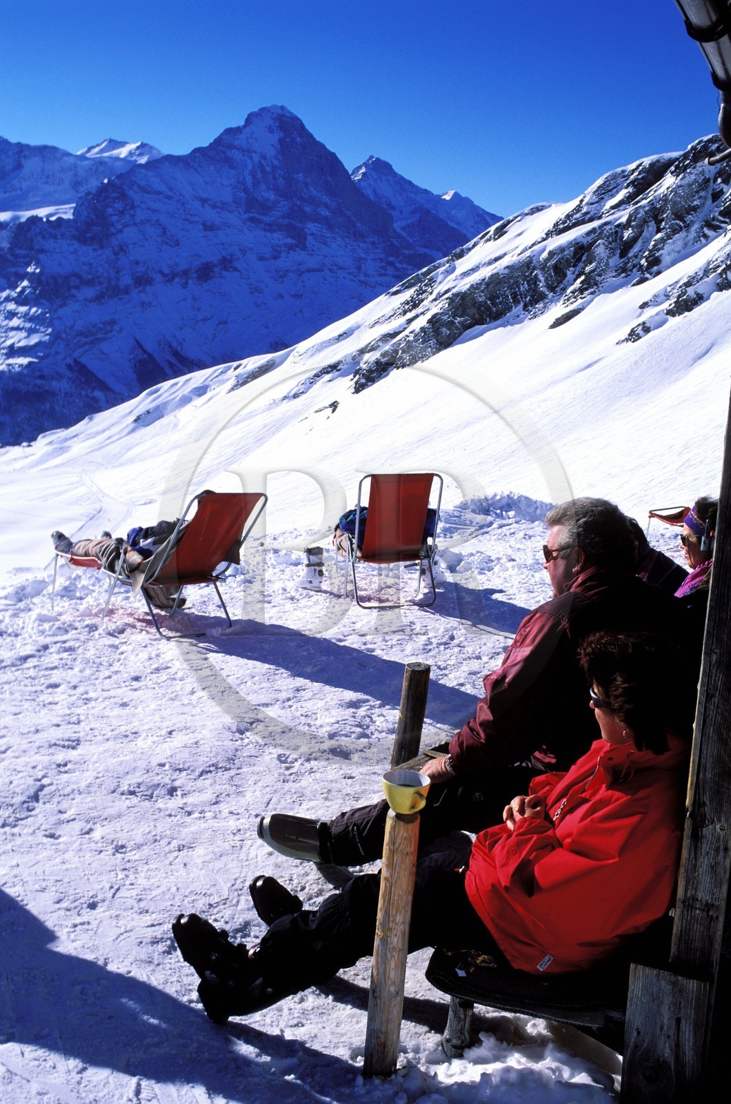 Switzerland, Bern Region (Bernese Oberland), Grindenwald, skier resting on the ìFirst (2501m) mountain top