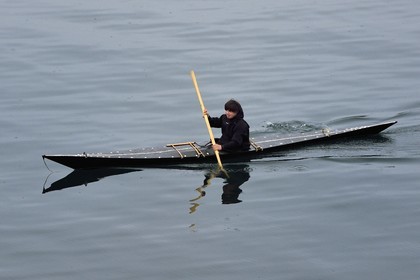 Greenland, central western region, Sisimiut (formerly Holsteinsborg), Inuit in a traditional kayak