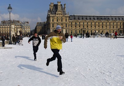 France, Paris (75), course dans la neige devant Le Louvre