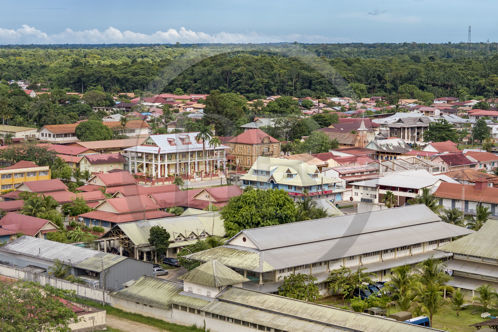 France, French Guiana, Saint-Laurent-du-Maroni bordering the forest, located on Lieutenant-Colonel Chandon Avenue which notably houses the town hall, the former central bank, and the Saint-Laurent-du-Maroni church (aerial view)