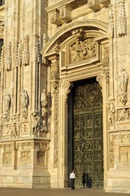 Italy, Lombardy, Milan, the Duomo in the historical center, cathedral in Gothic Flamboyant style, central portal surmounted by a tympanum representing the Creation of Eve (drawings by Cerano)