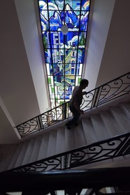 France, Alpes de Haute Provence, Ubaye valley, Barcelonnette, mexican villa known as the Blue Villa,  8.10 m high stained glass created in 1933 by master glassmaker Gruber of the Nancy School representing looms sheets, smoking chimneys of textile factories and a department store, it celebrates the success in Mexico of its first owner Camille Jean founder of the Francia Maritima department store