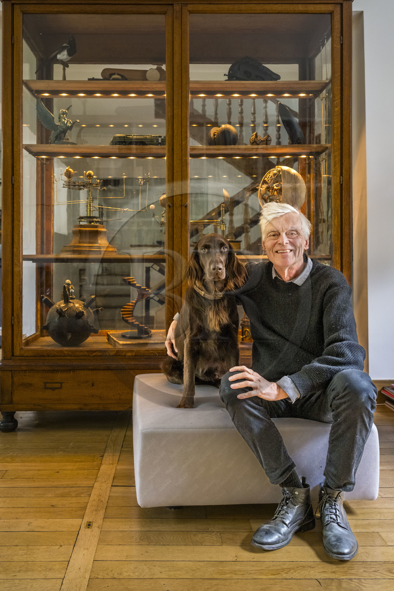 France, Paris, cartoonist and comic book author François Schuiten in his Parisian studio, with his dog Ulysses