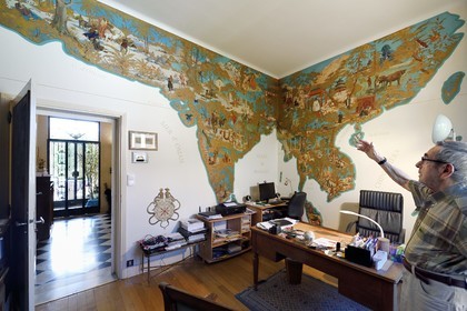 France, Allier (03), Vichy, Art Deco villa René Jeux, Paul Peronnet in his office, wall map of the Orient dreamed by travelers, from the deserts of Central Asia to the temples of Japan, hand painted on plywood by Max Moreau in 1942