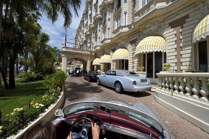 France, Alpes-Maritimes, Cannes, the Carlton palace on the boulevard de la Croisette, aboard a collection convertible Porsche Speedster 356