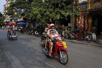 Vietnam, Hanoi, family on a motorcycle in the old city