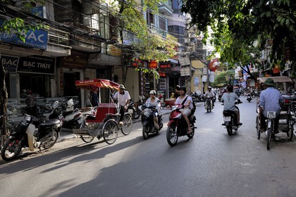 Vietnam, Hanoi, motorcycle and Rickshaw traffic in the old city
