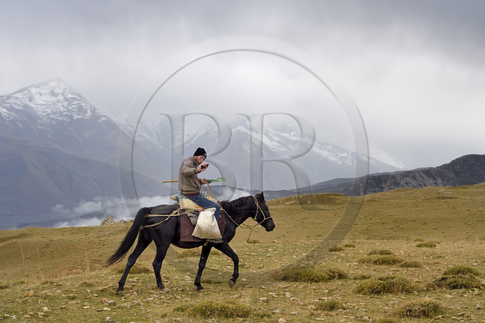 Azerbaijan, Quba (Guba) region, Greater Caucasus mountain range, summits in the clouds in the heights of the village of Giriz, breeder on horseback