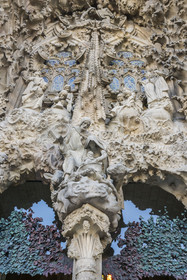 Spain, Catalonia, Barcelona, Eixample district, Sagrada Familia basilica by Catalan modernist architect Antoni Gaudi, listed as a UNESCO World Heritage Site, facade of the Nativity, the Charity Gate, the mother of God and Saint Joseph with Jesus just born