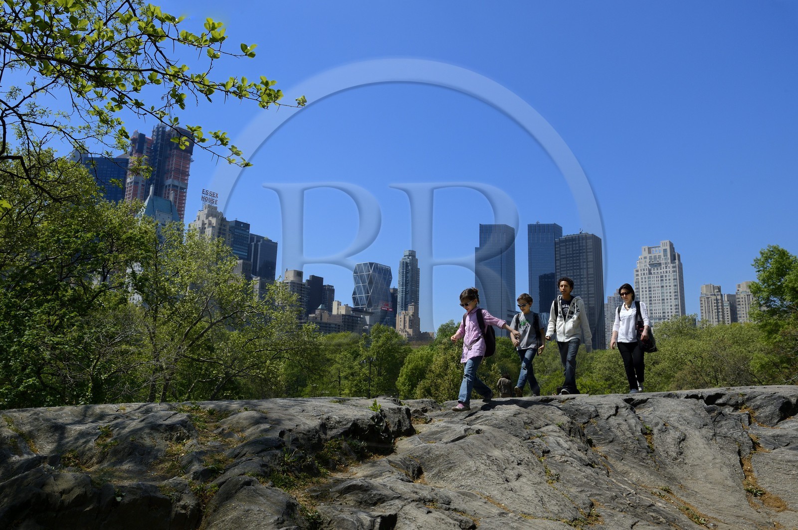 United States, New York City, Manhattan, Central Park, the rocks near the Pond, buildings of Midtown and the Time Warner Center (in the center) in the background