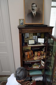 France, Alpes de Haute Provence, Ubaye valley, Jausiers, mexican villa known as Villa San Carlos, Sophie Meche-Fortoul granddaughter of Eugene Fortoul (framed portrait) who emigrated to Mexico in the early 20th century, memories cabinet of his adventure