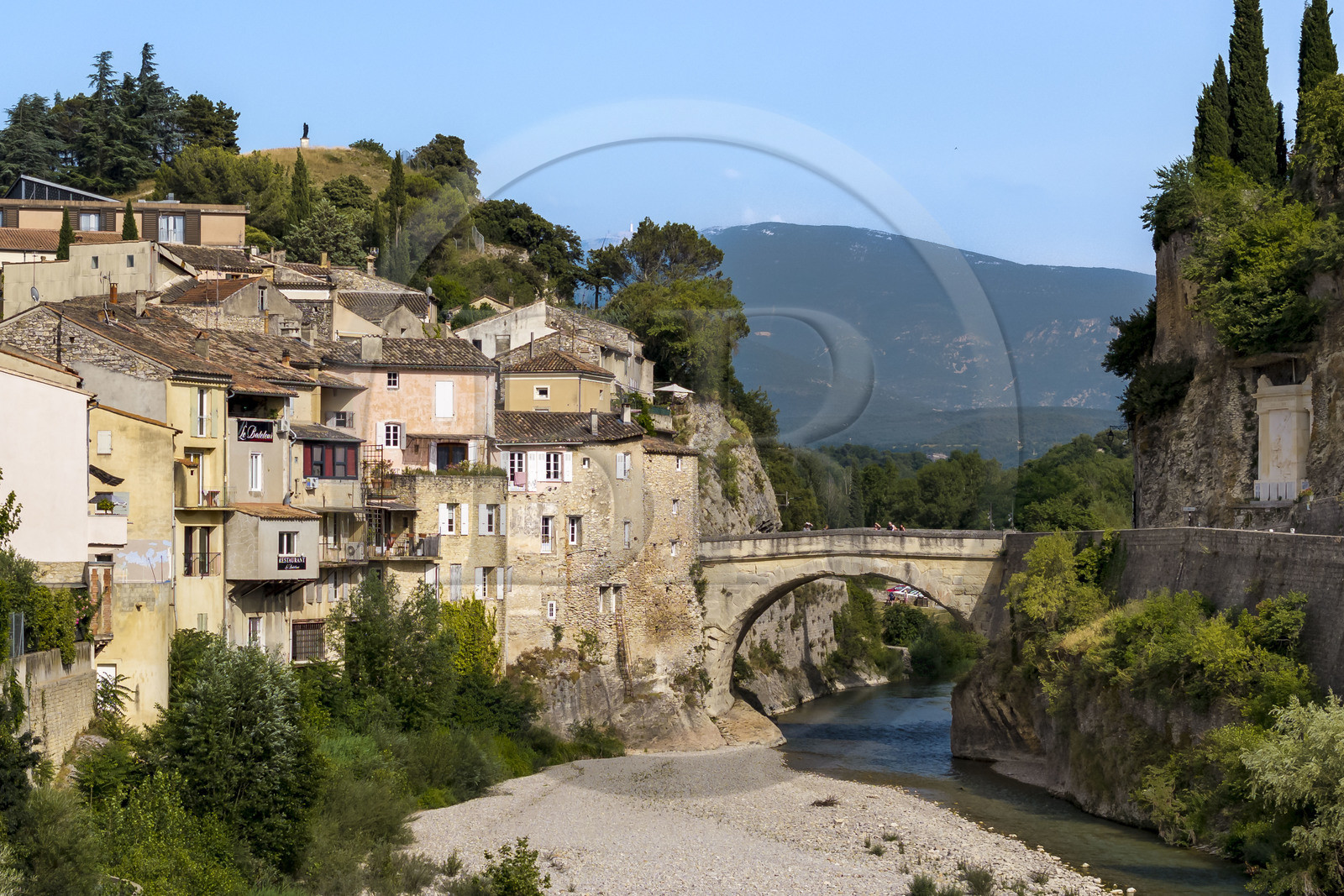 France, Vaucluse, Vaison la Romaine, the Roman bridge over the Ouvèze river dating from the 1st century AD which links the lower town and the medieval town, the Mont Ventoux in the background (aerial view)