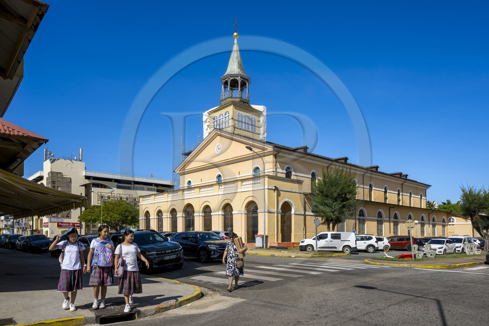 France, French Guiana, Cayenne, Saint Sauveur (Saint Saviour's) Cathedral in the Old Town, three schoolgirls in uniform leaving school
