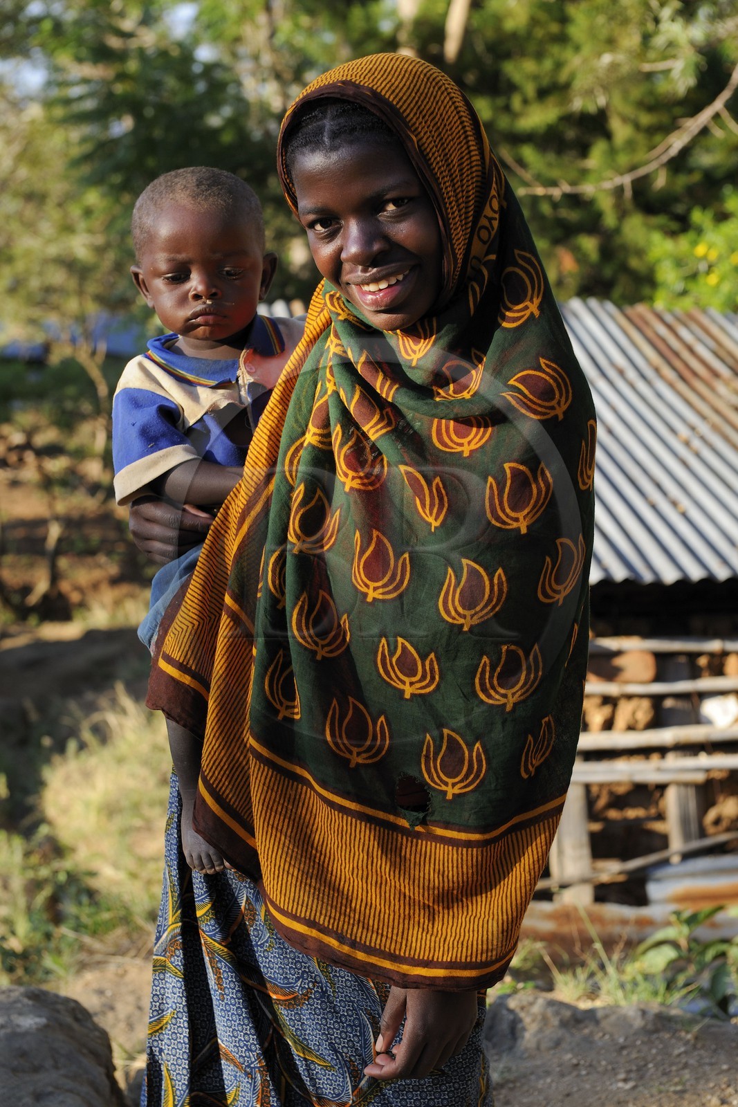 Tanzania, Morogoro district, Uluguru mountains, young girl carrying a child in a village around the former german refuge called Morningside