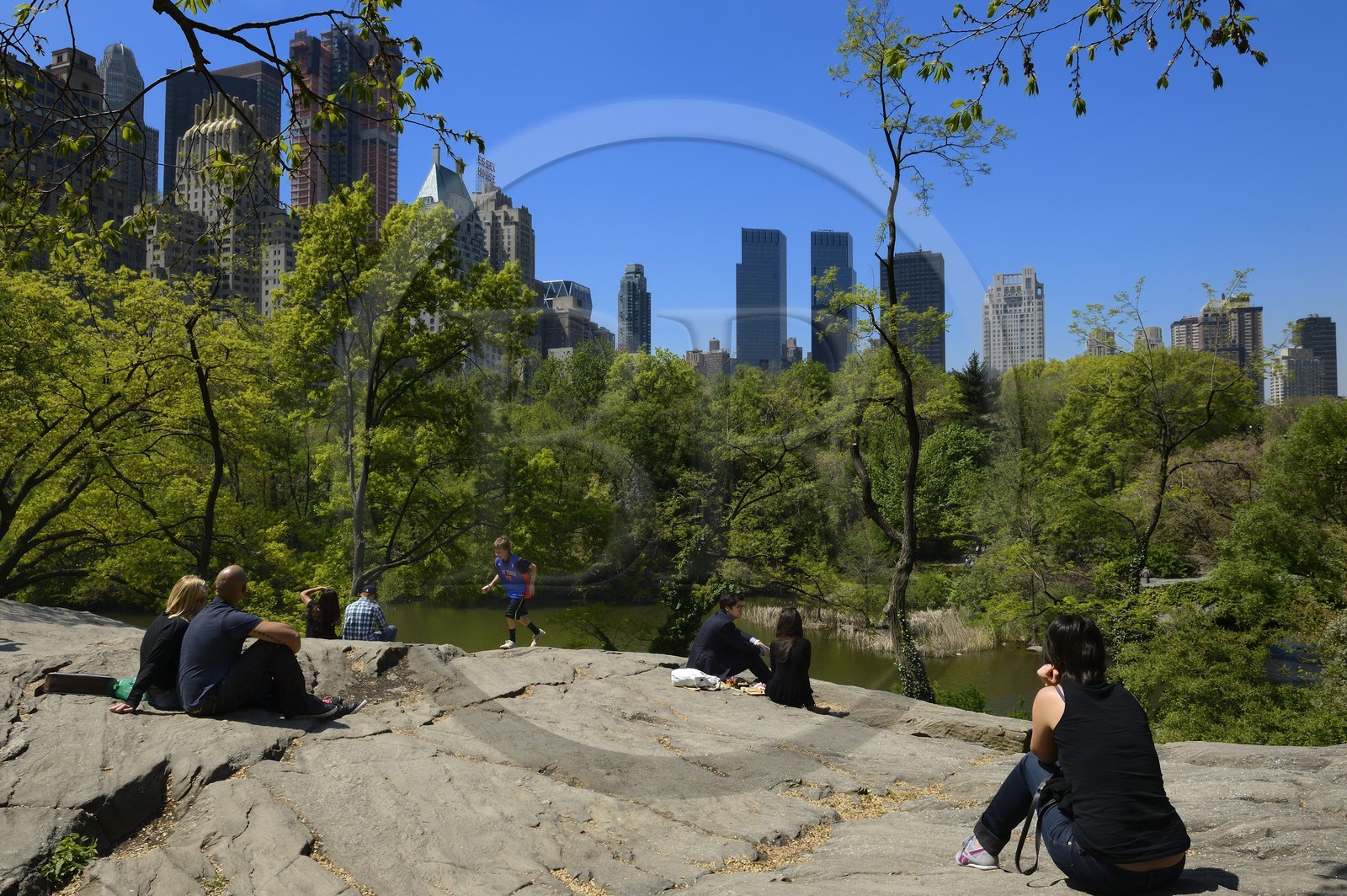 United States, New York City, Manhattan, Central Park, the rocks near the Pond, buildings of Midtown and the Time Warner Center (in the center) in the background