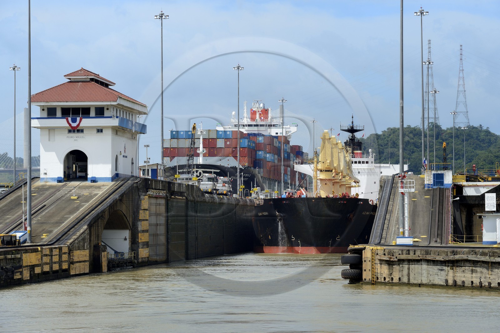 Panama, Panama Canal, Pedro Miguel locks, mechanical mules or electric locomotives guiding a Panamax cargo between the lock walls