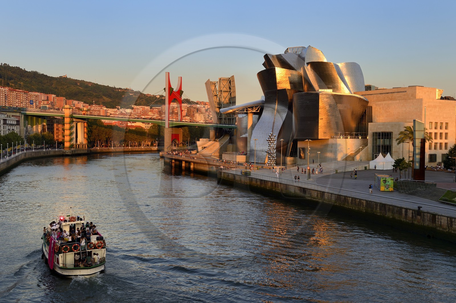 Spain, Basque Country Region, Vizcaya Province, Bilbao, the Guggenheim Museum designed by Frank Gehry and the Salve bridge with Les Arches Rouges artpiece by French artist Daniel Buren in the background