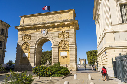 France, Herault, Montpellier, historic center called the Ecusson, the Arc de Triomphe (17th century) in rue Foch, the equestrian statue of Louis XIV and the Peyrou water tower in the background, the equestrian statue of Louis XIV and the Peyrou water tower in the background