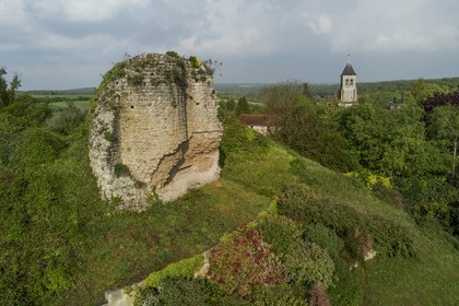 France, Yvelines, Montchauvet, ruins of the castle dungeon built in 1136 by Amaury de Montfort and Sainte Marie Madeleine (St. Mary Magdalene) church in the background