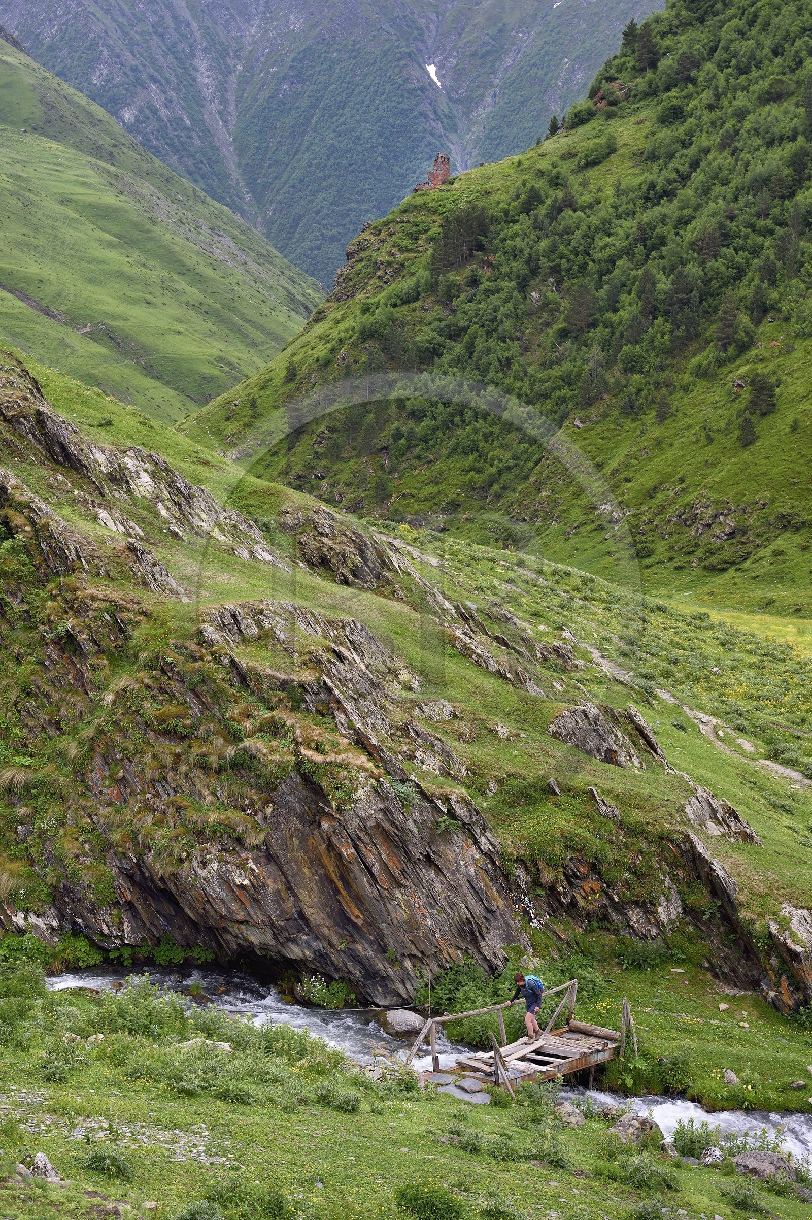 Georgia, Kakheti, Tusheti National Park, Alazani River Valley in the mountains of Pirikiti, Parsma (Baso), hiker crossing the river