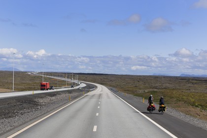Iceland, Reykvavik, cyclists on the road to Keflavik