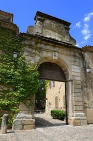 France, Herault, Villeneuvette, main gate of the former royal factory, on the pediment we can see the words Honor to work