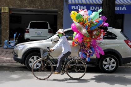 Vietnam, Hanoi, kid's balloon seller on bicycle