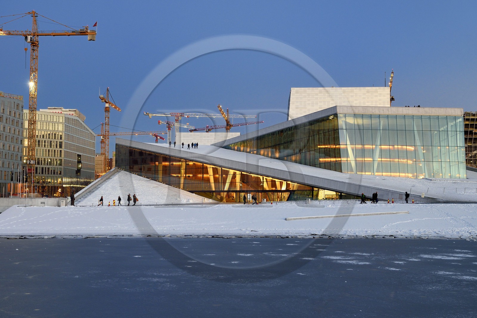 Norway, Oslo, the Opera under the snow, designed by the architecture firm Snohetta (including Tarald Lundevall) on the commercial and industrial port of Bjorvika district undergoing restructuring