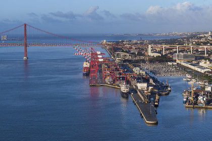 Portugal, Lisbon, Lisbon port and the Doca de Alcantara on the banks of the Tagus, the Ponte 25 de Abril in the background (aerial view)