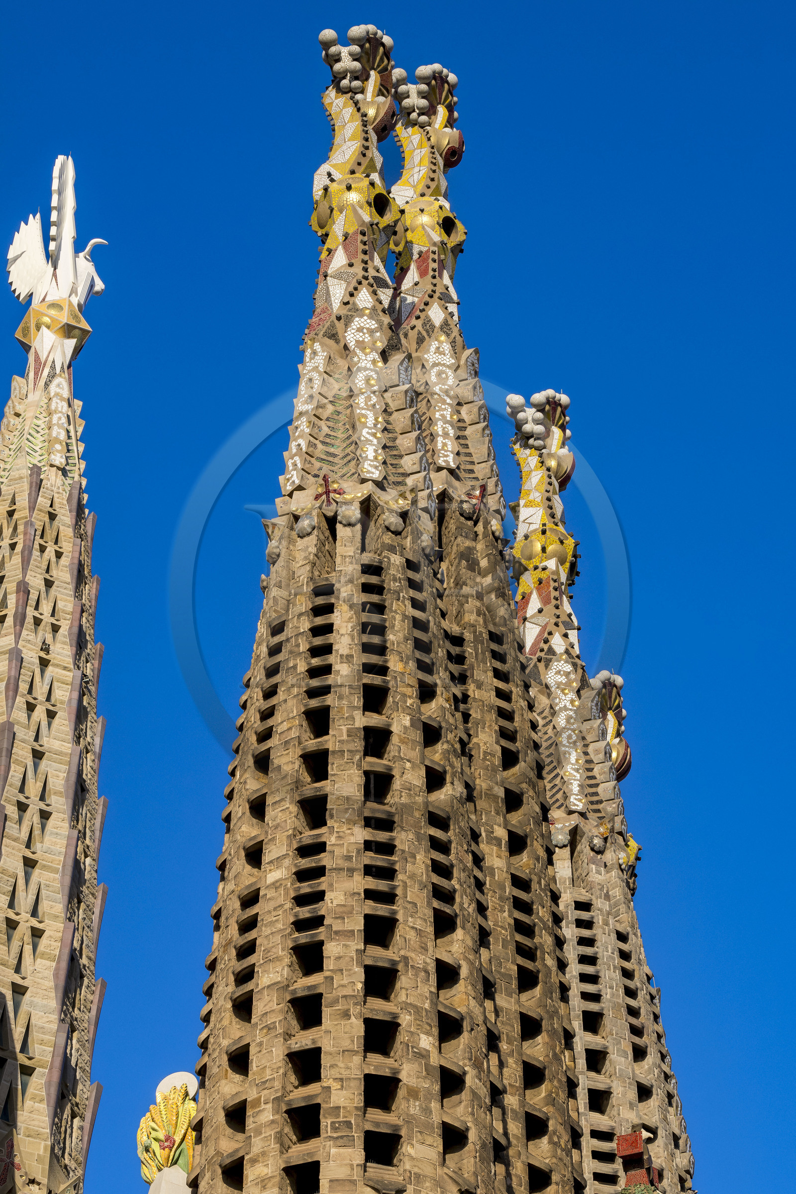 Spain, Catalonia, Barcelona, Eixample district, Sagrada Familia basilica by Catalan modernist architect Antoni Gaudi, listed as a UNESCO World Heritage Site, Venetian mosaic pinnacle of the Towers of the Apostles, one of the four 135-metre bell towers surrounding the central ciborium whose pinnacle is crowned by the winged bull, symbol of Saint Luke