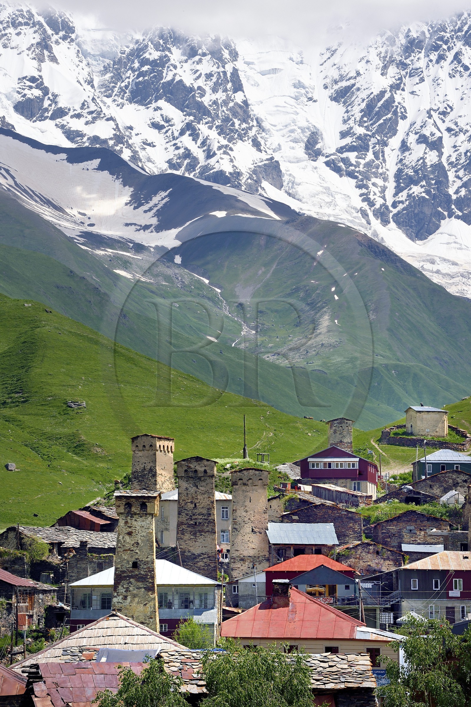 Georgia, Upper Svaneti (Zemo Svaneti), village of Ushguli, listed as World heritage by UNESCO, Svan defensive towers erected next to the houses and Mount Chkhara (highest peak in Georgia with 5,193 m) in the background
