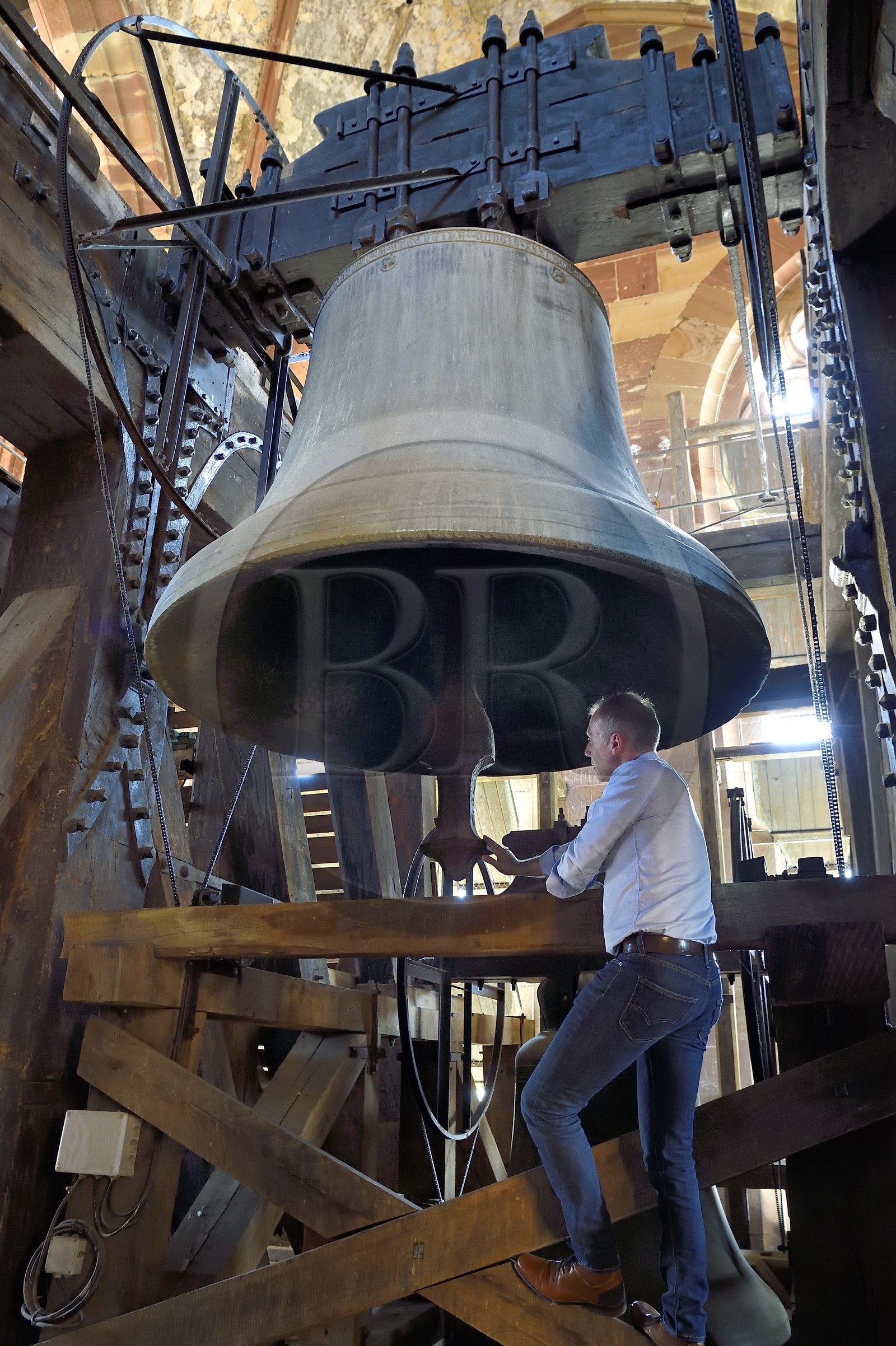 France, Bas Rhin, Strasbourg, old town listed as World Heritage by UNESCO, Notre Dame Cathedral, the central belfry, the campanologist of the diocese Olivier Tarozzi in front of the 9 tons big bourdon bell dating from 1427