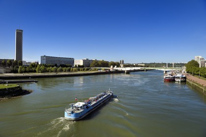 France, Seine Maritime, Rouen, barge on the Seine and the Boieldieu Bridge, the departmental archives tower of Seine-Maritime in the background