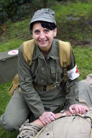 France, Eure, Sainte Colombe prés Vernon, Allied Reconstitution Group (US World War 2 and french Maquis historical reconstruction Association), the reenactor Valerie Amblot as a nurse from the 101st US Airborne Division caring for a wounded soldier