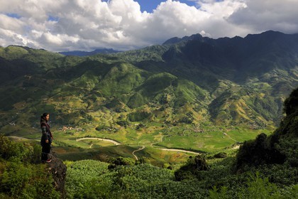 Vietnam, Lao Cai province, Sapa district, young woman from the Black Hmong minority group overlooking her valley Hau Thao