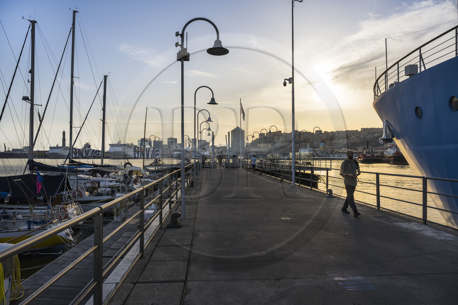 Italy, Liguria, Genoa, the exit of Porto Antico (Old Port) and the Lanterna lighthouse which dominates the commercial port in the background