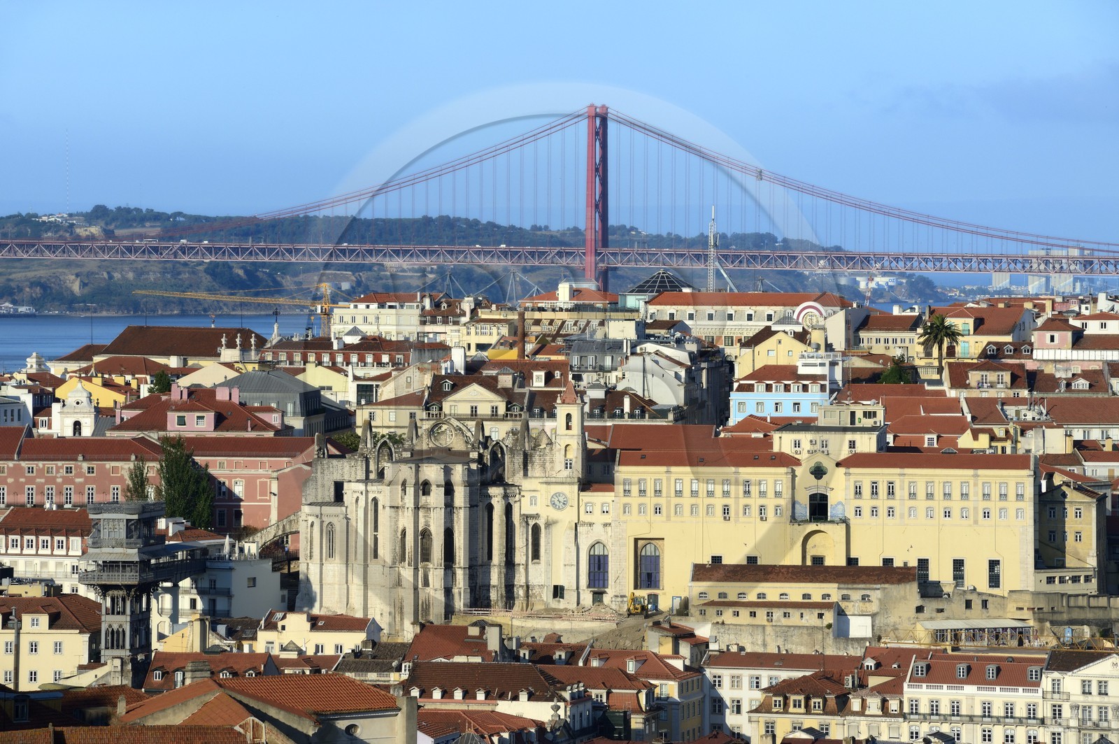 Portugal, Lisbon, the Gothic ruins of Carmo 15th century church partly destroyed by 1755 earthquake, Bairro Alto district and the 25 de Abril bridge on Tagus river in the background
