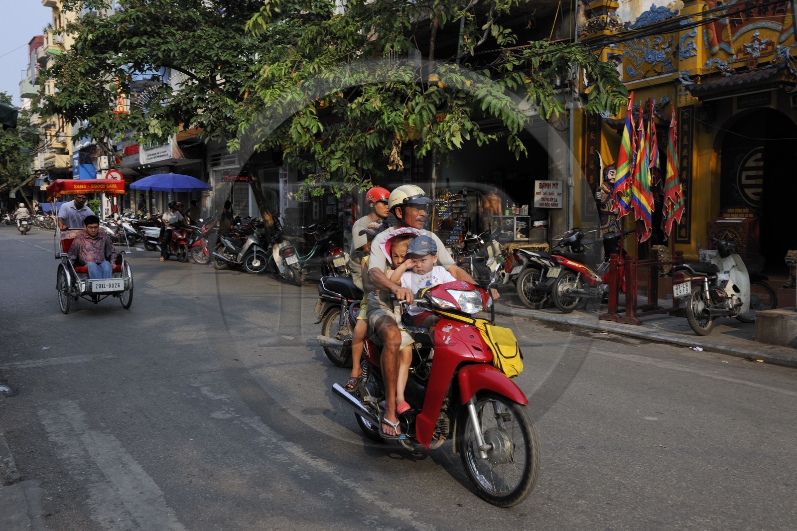 Vietnam, Hanoi, family on a motorcycle in the old city